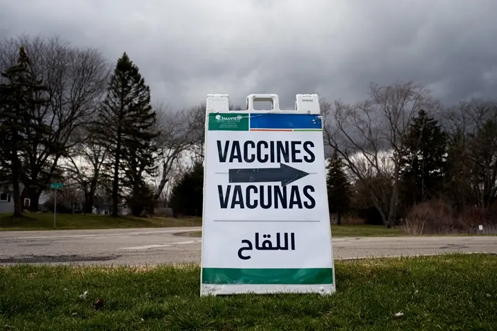 A sign pointing to a clinic where residents who are over 50 years old and immunocompromised can receive their second booster shots of the coronavirus disease (COVID-19) vaccines in Waterford, Michigan, U.S., April 8, 2022. REUTERS/Emily Elconin/File Photo