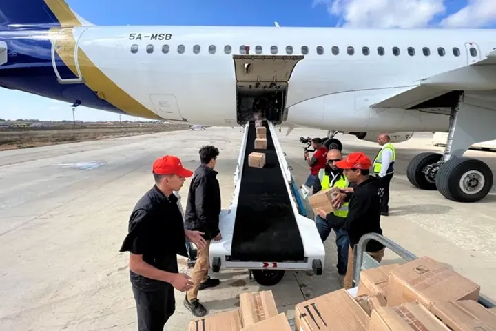 Members of Libya's Youth Hostels Association unload medical aid that arrived by plane at al Abraq airport, Libya September 12, 2023. REUTERS/Ayman Al-Sahili