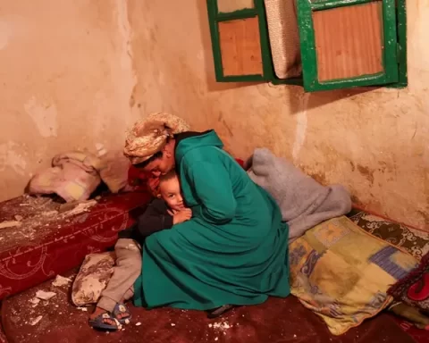 Hasna, 44, kisses her son Mohamed Jad, 5, inside their damaged house in Moulay Brahim village, in the province of Al Haouz, following a powerful earthquake in Morocco, September 9, 2023. REUTERS/Nacho Doce