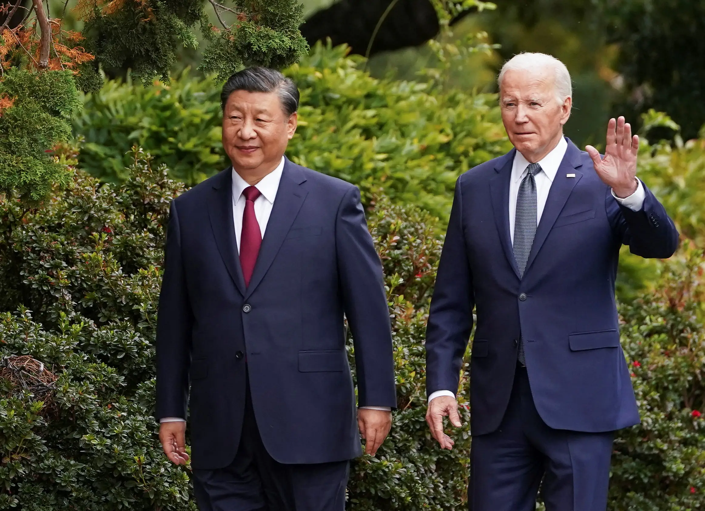 U.S. President Joe Biden waves as he walks with Chinese President Xi Jinping at Filoli estate on the sidelines of the Asia-Pacific Economic Cooperation (APEC) summit, in Woodside, California, U.S., November 15, 2023