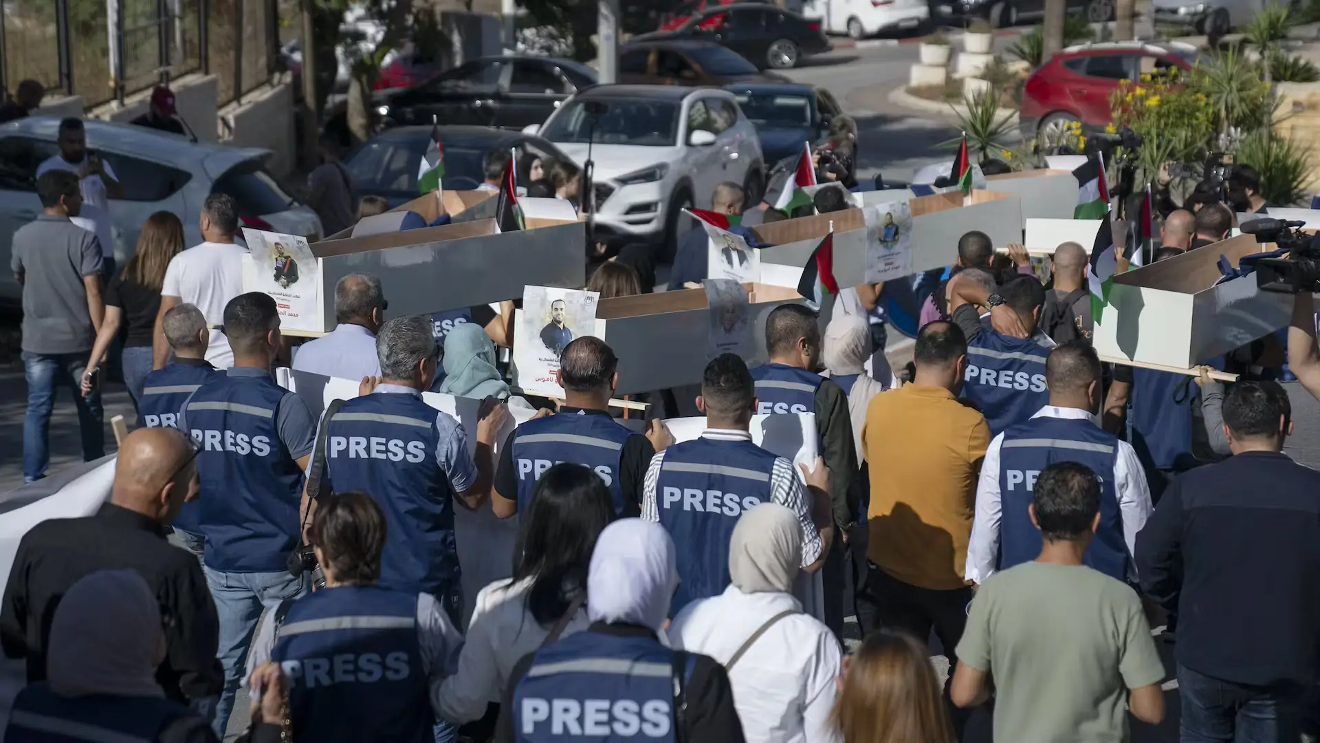 Palestinian journalists carry mock coffins representing journalists killed during the war in Gaza, Ramallah, West Bank, November 7, 2023. Nasser Nasser/AAP