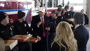 Former President Donald Trump talks with fire fighters in Waukee, Iowa.