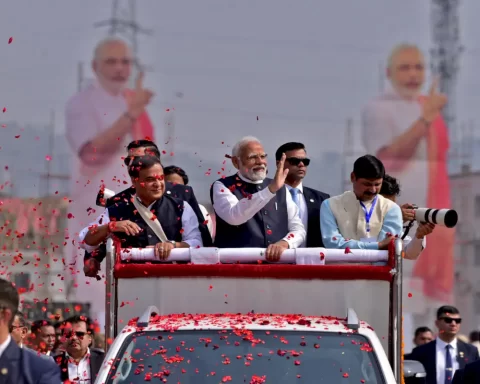 India's Prime Minister Narendra Modi waves to his supporters as he arrives to attend a rally in Guwahati, India, February 4, 2024. REUTERS/Anuwar Hazarika