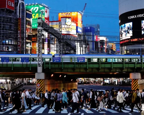 People cross a road in Shinjuku, Tokyo, Japan