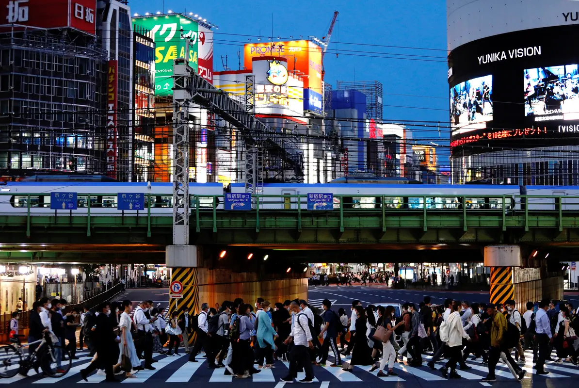 People cross a road in Shinjuku, Tokyo, Japan