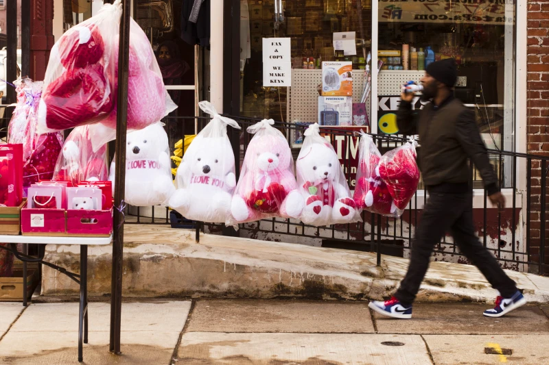 pedestrian passes Valentines day stuffed animals for sale ahead of the holiday in Philadelphia