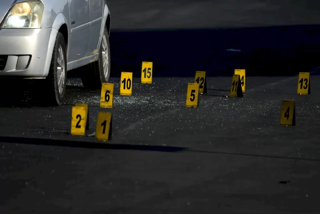Evidence markers indicate the location of bullet casings at a crime scene