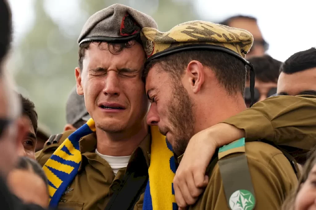 Soldiers and friends of Israeli soldier, Sergeant Dolev Malca, mourn in grief during his funeral in Shlomi, northern Israel, on the border with Lebanon, Sunday, March 3, 2024. Malca ,19, was killed during Israel’s ground operation in the Gaza Strip, where the Israeli army has been battling Palestinian militants in the war ignited by Hamas’ Oct. 7 attack into Israel. (AP Photo/Ariel Schalit)