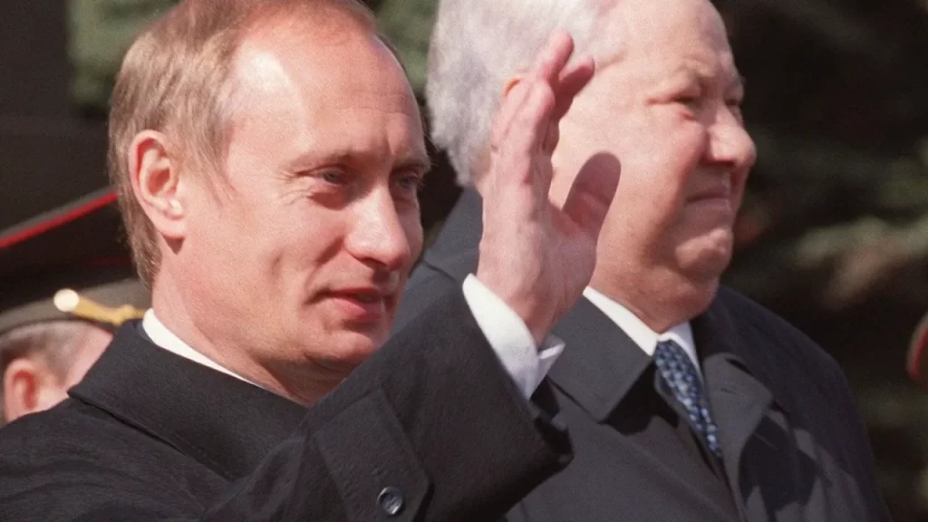 Vladimir Putin (left) with Boris Yeltsin during a parade on Red Square in 2000. Anonymous/AP