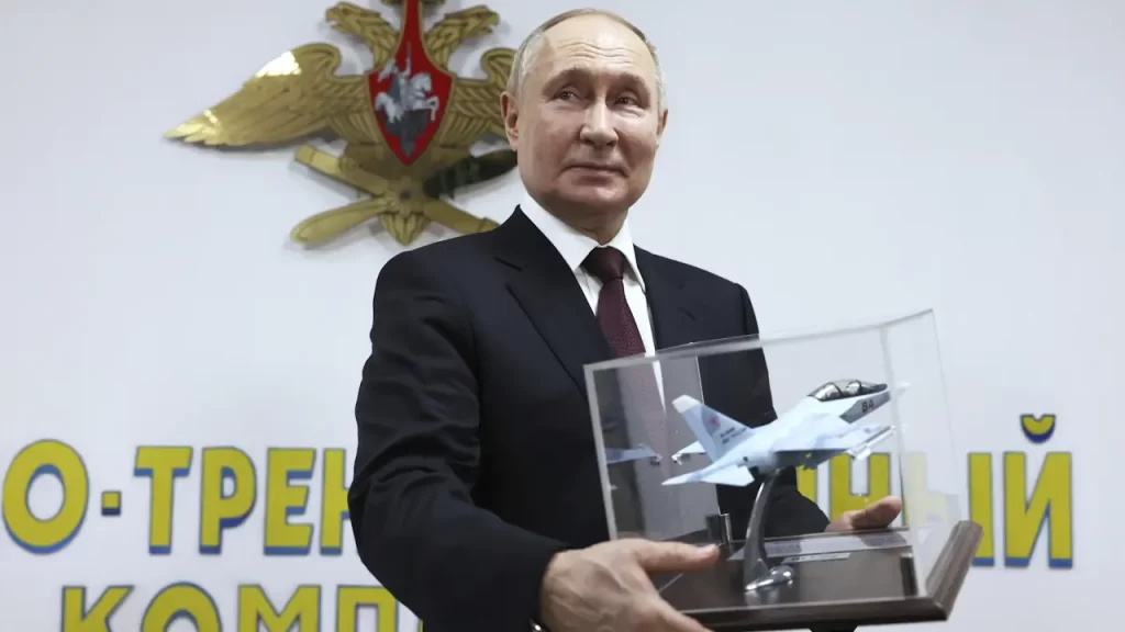 Vladimir Putin is presented with a gift during a visit to an aviation school in Krasnodar, Russia, last week.