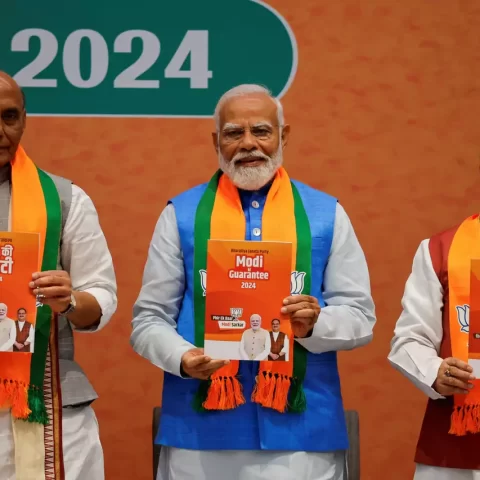 Indian Defence Minister Rajnath Singh, Prime Minister Narendra Modi and President of the Bharatiya Janata Party J. P. Nadda display copies of the ruling Bharatiya Janata Party's (BJP) election manifesto for the general election, in New Delhi, India, April 14, 2024. REUTERS/Adnan Abidi Purchase Licensing Rights