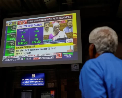 A man watches a screen displaying India's Fin Min. Nirmala Sitharaman's budget speech