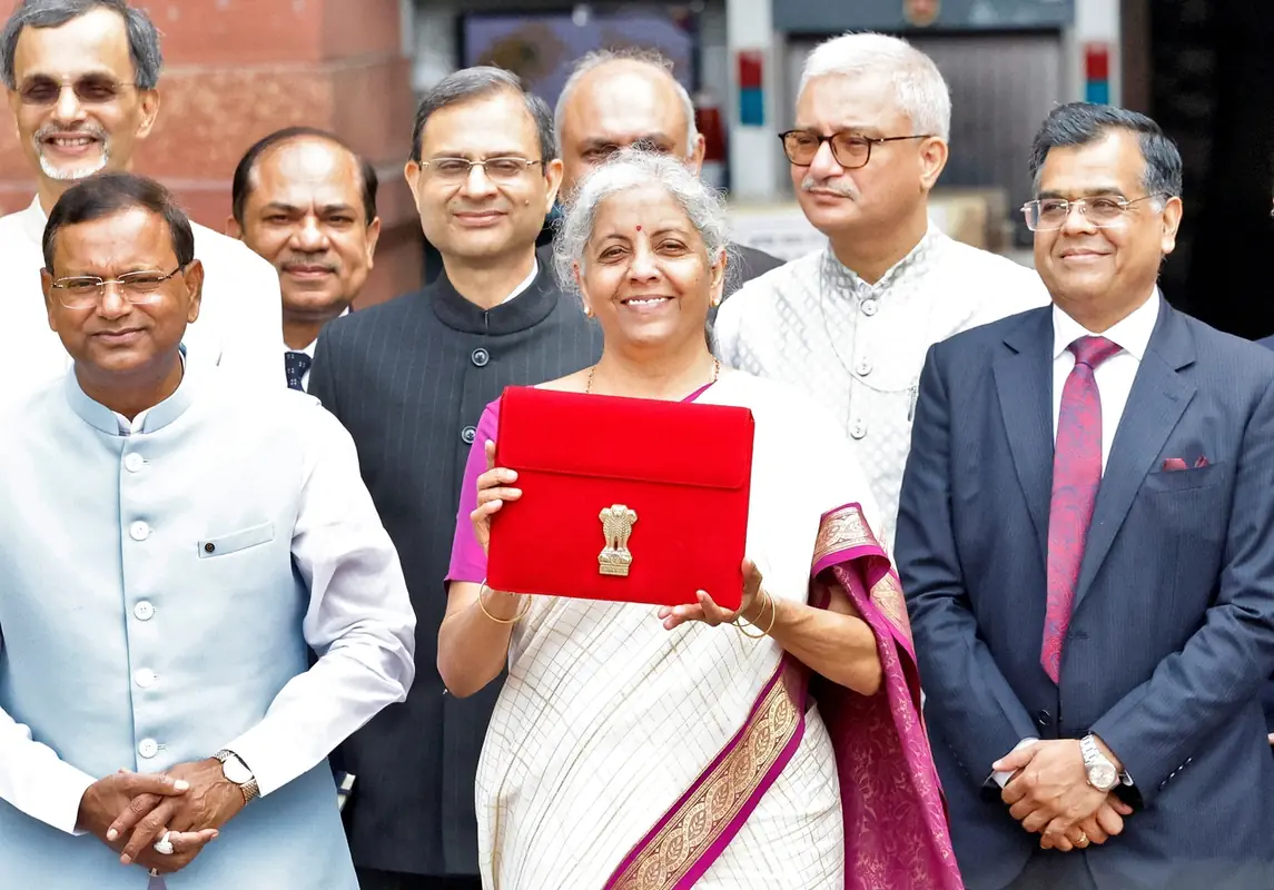 India's Finance Minister Nirmala Sitharaman holds up a folder with the Government of India's logo as she leaves her office to present the union budget in the parliament in New Delhi, India, July 23, 2024. REUTERS/Altaf Hussain