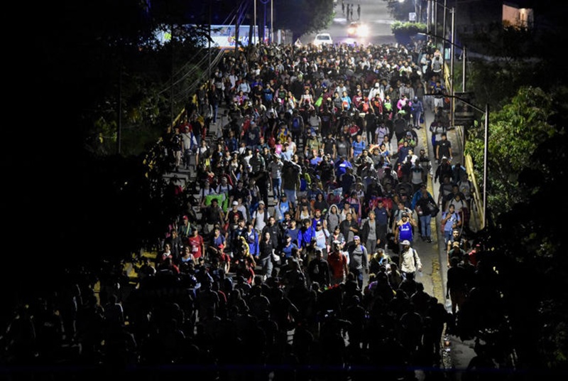 Migrants walk through Tapachula