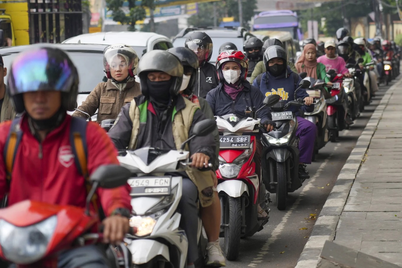 Motorists wait in a traffic jam in Jakarta