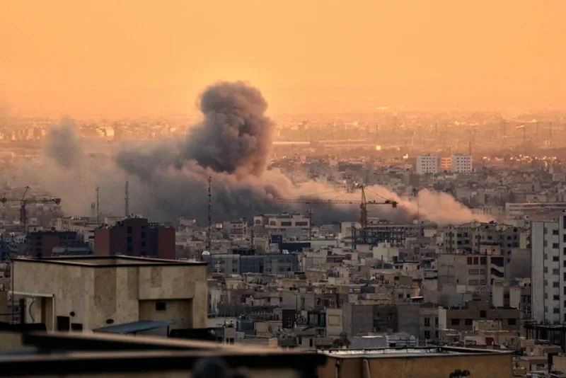 Israel steps up airstrikes in Tehran, as Iran widens its response across the region 2 plume of smoke rises