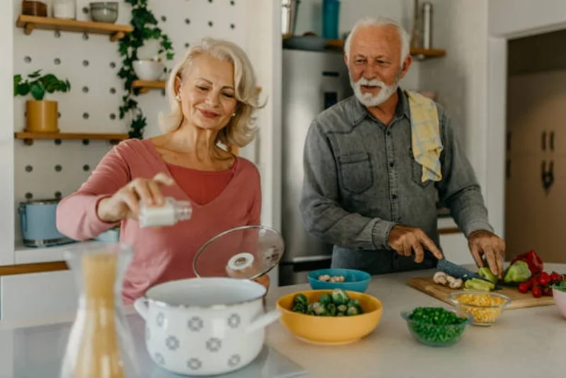 Elderly Couple adding salt