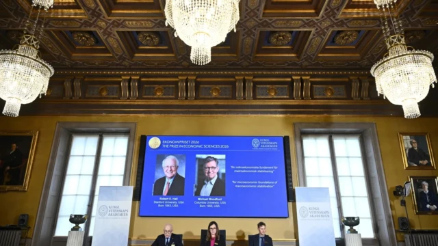 <center><i>ortraits of Robert E. Hall and Michael Woodford are shown on the screen as they are announced as the laureates of the Sveriges Riksbank Prize in Economic Sciences in Memory of Alfred Nobel at the Royal Swedish Academy of Sciences in Stockholm, Sweden, Monday, Oct. 12, 2026. (Photo: AP)</i></center> 3689567314