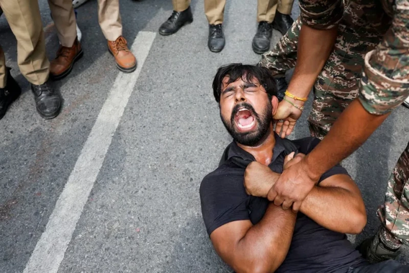 <center><i>A protester is detained by security personnel during a protest by the Cockroach Janta Party (CJP) seeking the resignation of India's Chief Election Commissioner Gyanesh Kumar, near the protest site in New Delhi, India, October 11, 2026. (Photo: Reuters) </center></i> 260081121