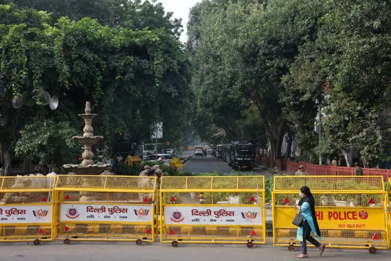 <center><i>A woman walks past barricades set up by Delhi Police on the second day of protests by the Cockroach Janta Party (CJP) demanding the resignation of India's Chief Election Commissioner Gyanesh Kumar, in New Delhi, India, October 11, 2026. (Photo: Reuters) </center></i> 2243877035