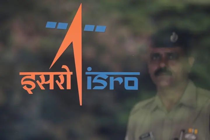 A security guard stands behind the logo of Indian Space Research Organisation (ISRO) at its headquarters in Bengaluru, India, June 12, 2019. REUTERS