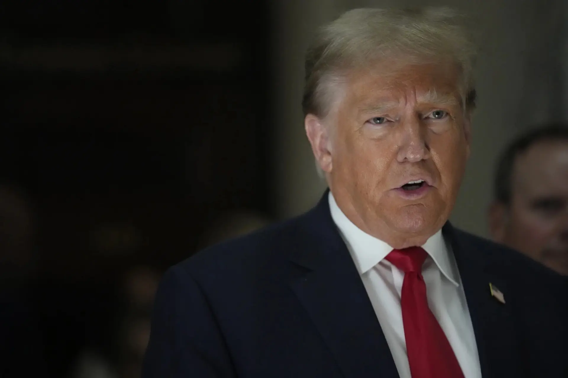 Donald Trump speaks to reporters as he leaves the courtroom during a lunch break in his civil business fraud trial, Oct. 4, 2023.