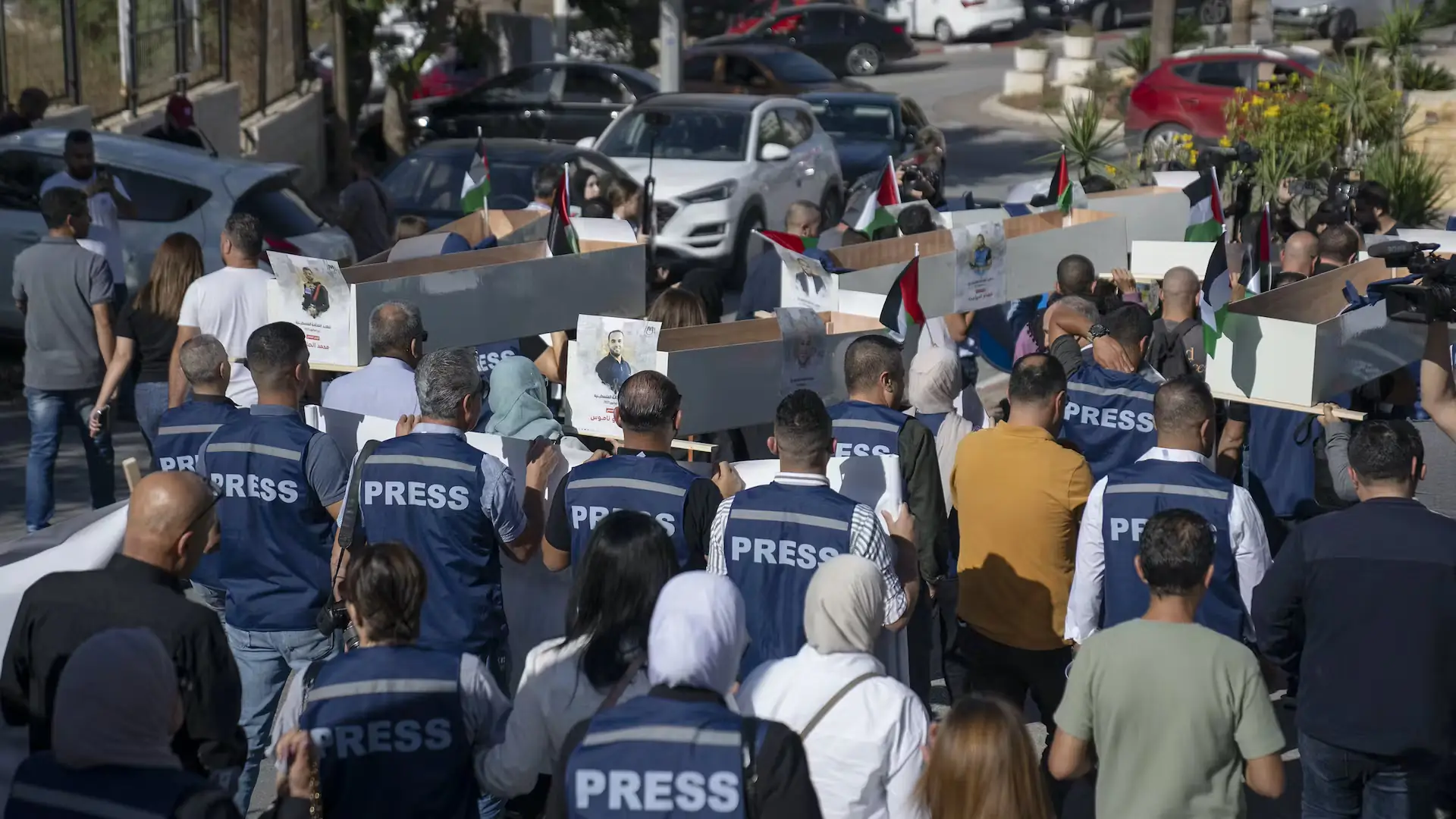 More than one journalist per day is dying in the Israel-Gaza conflict. This has to stop 2 Palestinian journalists carry mock coffins representing journalists killed during the war in Gaza, Ramallah, West Bank, November 7, 2023. Nasser Nasser/AAP