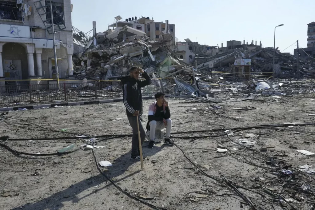 Palestinians fight in hard-hit areas of Gaza while a deal emerges to deliver medicine to hostages 2 Palestinians look at the destruction by the Israeli bombardment in the Nusseirat refugee camp in Gaza Strip Tuesday Jan. 16 2024