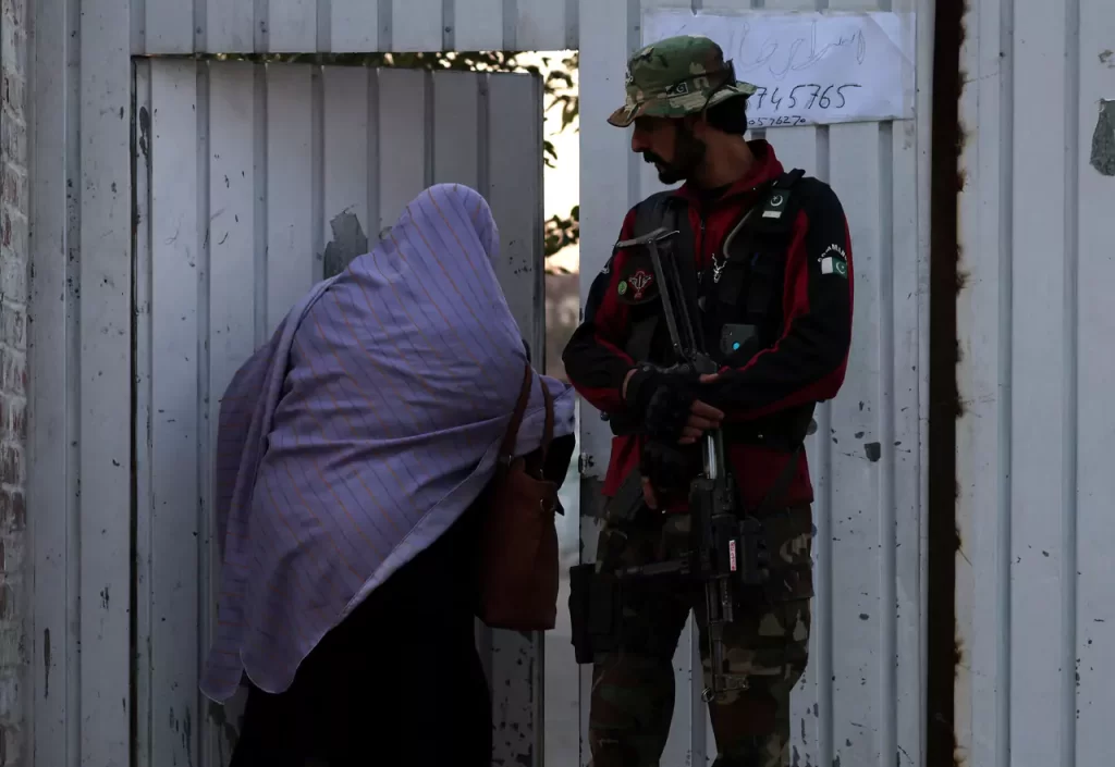 Mobile phone services suspended across Pakistan as voting begins 1 Polling staff enters a polling station as a police officer stands guard in Gulbahar area in Peshawar Pakistan