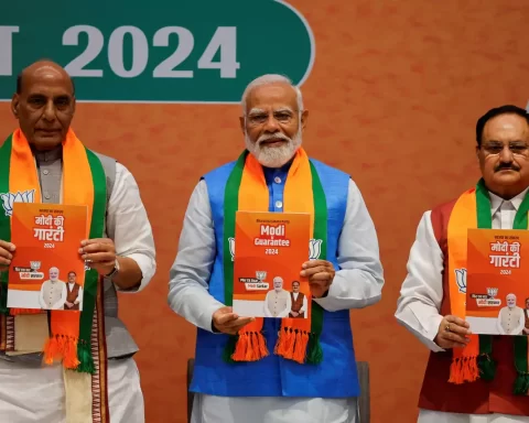Indian Defence Minister Rajnath Singh, Prime Minister Narendra Modi and President of the Bharatiya Janata Party J. P. Nadda display copies of the ruling Bharatiya Janata Party's (BJP) election manifesto for the general election, in New Delhi, India, April 14, 2024. REUTERS/Adnan Abidi Purchase Licensing Rights