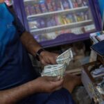 A man counts Indian rupee currency notes inside a shop in New Delhi, India. (Photo: Reuters)