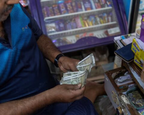 A man counts Indian rupee currency notes inside a shop in New Delhi, India. (Photo: Reuters)