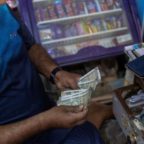 A man counts Indian rupee currency notes inside a shop in New Delhi, India. (Photo: Reuters)