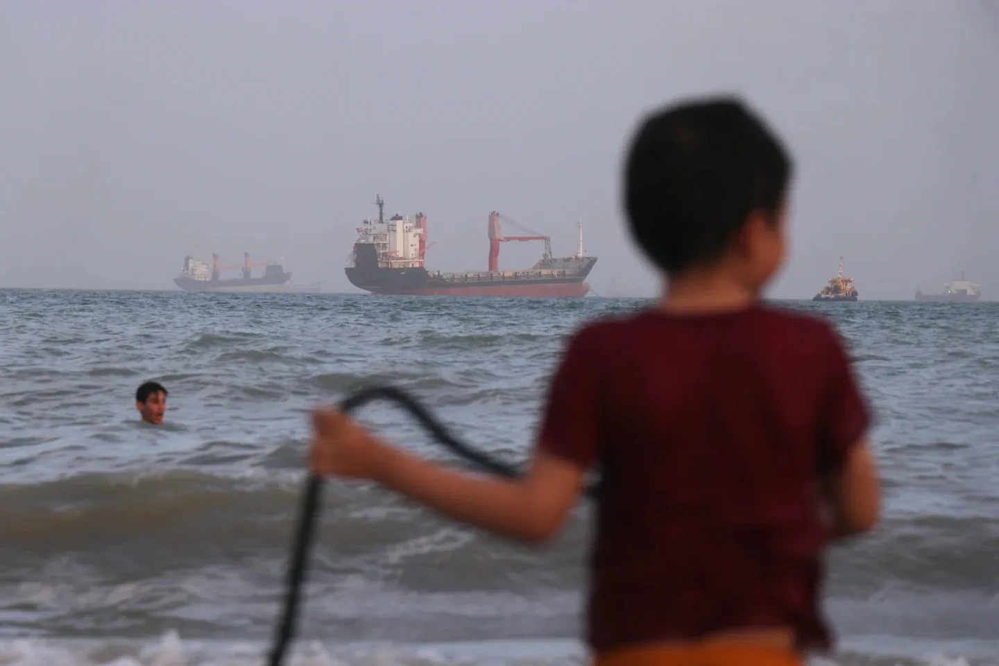 US military says it intercepted Iranian attacks on 3 Navy ships in Strait of Hormuz 4 Children play in the water Strait of Hormuz