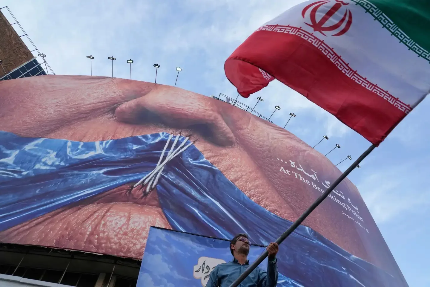 US military says it intercepted Iranian attacks on 3 Navy ships in Strait of Hormuz 1 man waves Iranian flag